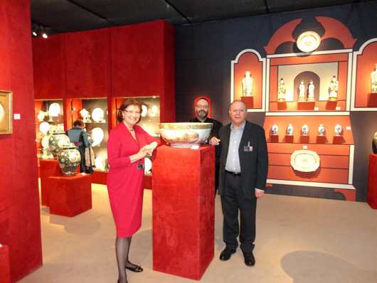 The new BADA chairman Michael Cohen (right) and his wife, Ewa, with their assistant William Motley, on their stand at the European Fine Art Fair in Maastricht. Mr. Cohen has announced sweeping new innovations at BADA. Image Auction Central News.